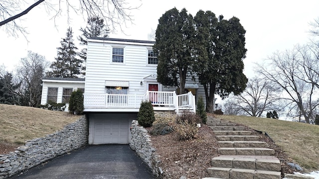 view of front of home featuring aphalt driveway and an attached garage