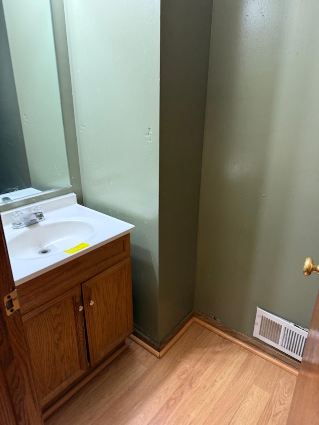 bathroom with vanity and hardwood / wood-style flooring