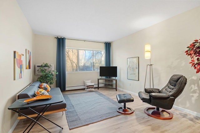 living area featuring a baseboard radiator, a wall unit AC, and light hardwood / wood-style floors