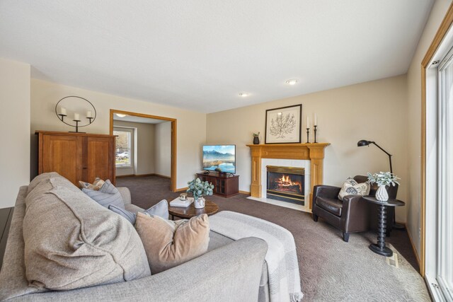 carpeted living room featuring a fireplace and baseboards