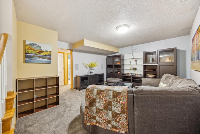 living area with carpet floors and a textured ceiling