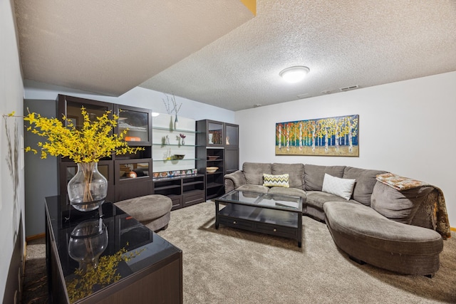 carpeted living area featuring a textured ceiling