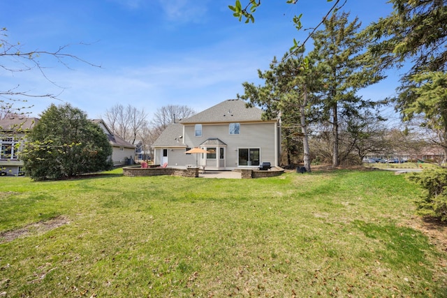 rear view of house with a patio area and a lawn