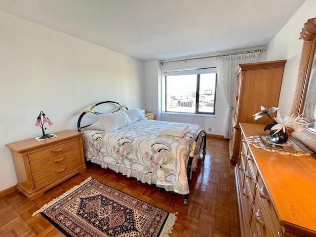 bedroom featuring a textured ceiling and baseboards