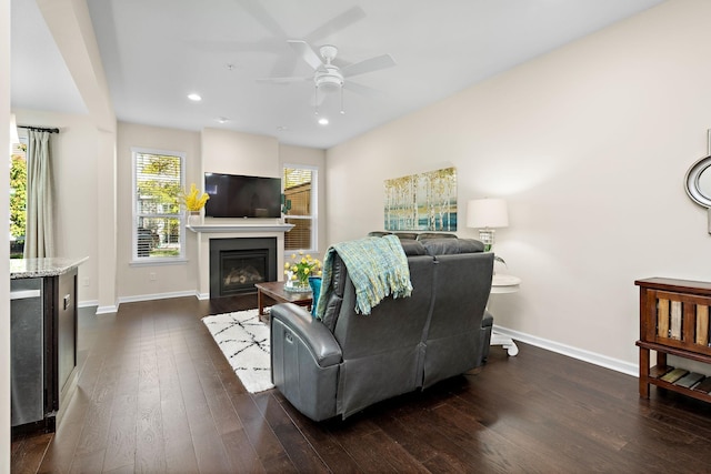 living room with dark wood-type flooring and ceiling fan