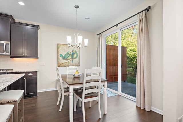 dining room featuring dark wood-type flooring and a chandelier