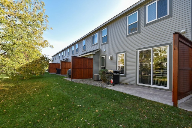 back of property featuring a yard and a patio