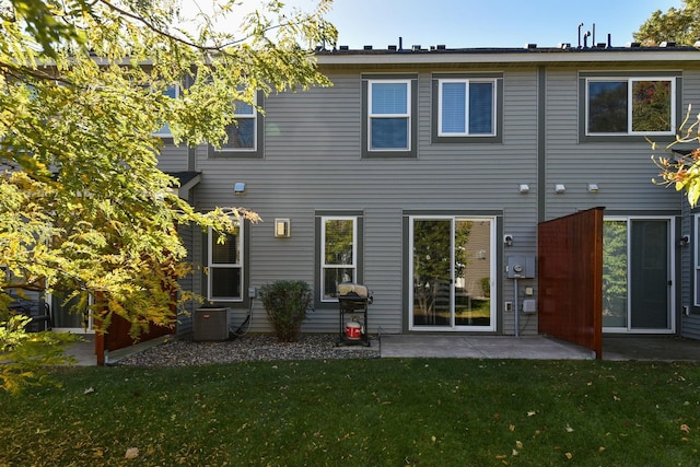 back of house with a yard, central AC, and a patio