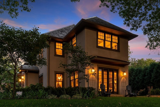 view of back house at dusk