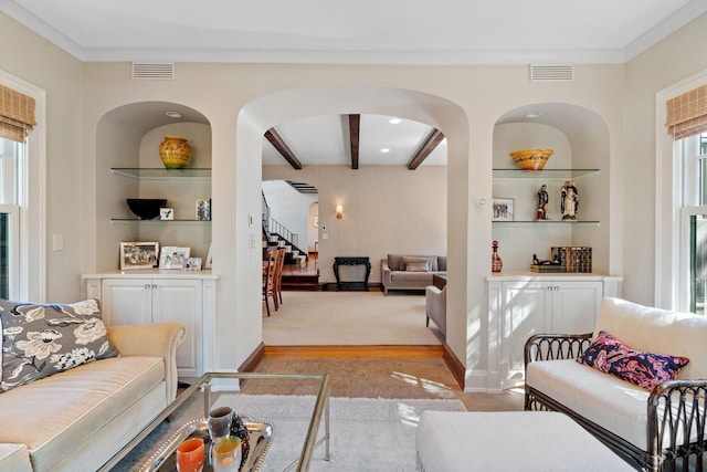 living room with beamed ceiling and built in features