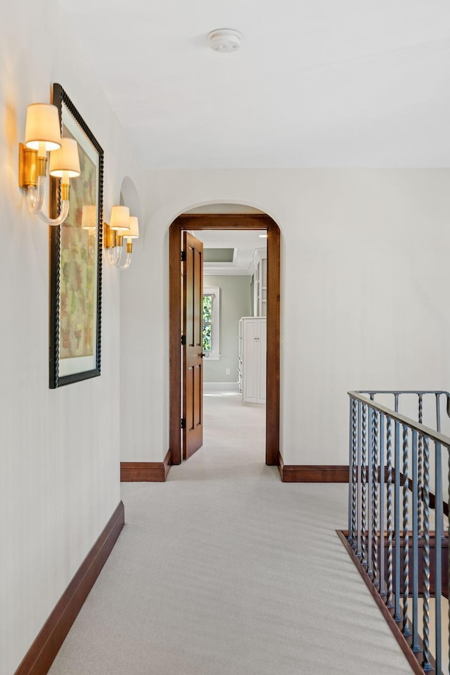 corridor featuring light colored carpet