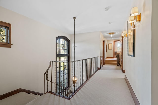 hallway with light colored carpet