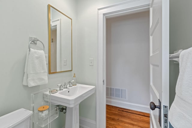 bathroom featuring hardwood / wood-style flooring, sink, and toilet