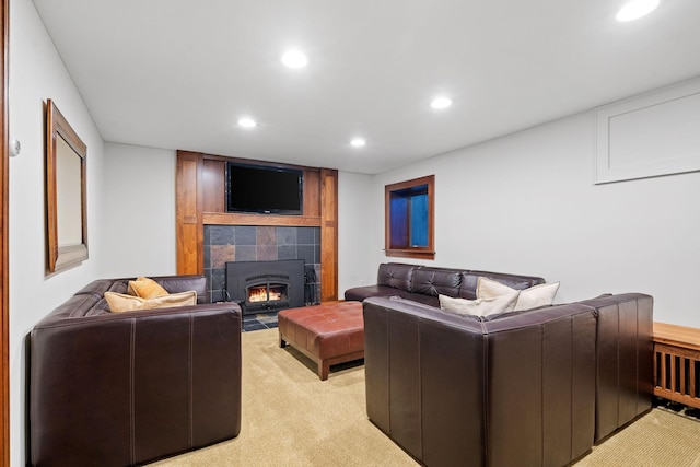 living room featuring a fireplace and light colored carpet