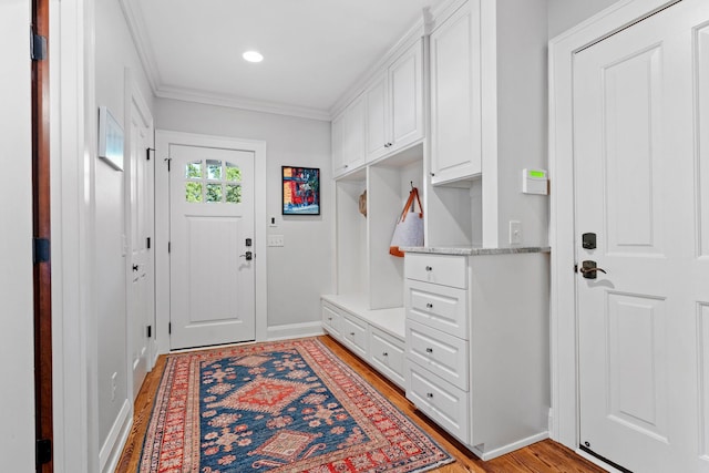 mudroom featuring light hardwood / wood-style flooring and ornamental molding