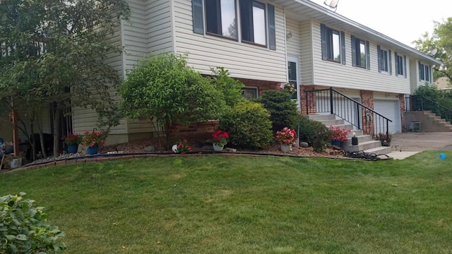 view of home's exterior featuring a garage and a lawn