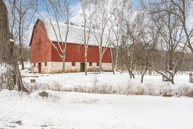 yard layered in snow featuring an outdoor structure