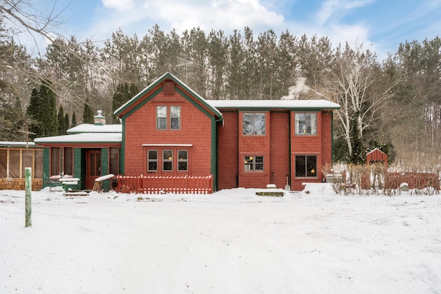 snow covered property with a porch