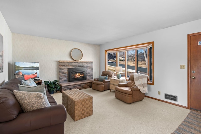 living room featuring carpet floors, a brick fireplace, visible vents, and baseboards