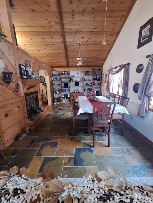 dining area with wood ceiling and high vaulted ceiling