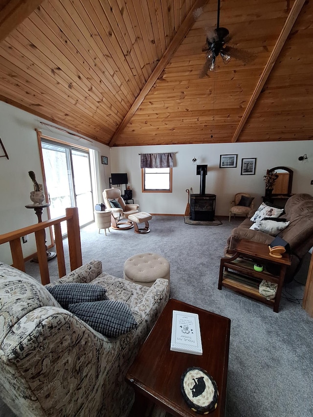 living area featuring lofted ceiling, wooden ceiling, ceiling fan, a wood stove, and carpet floors