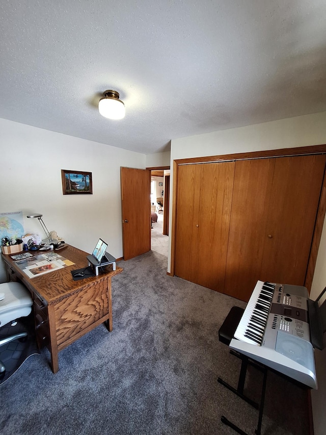 office space featuring a textured ceiling and dark colored carpet