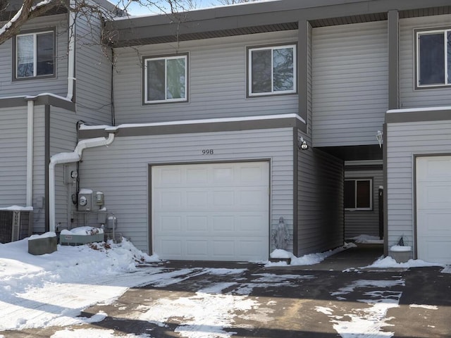 exterior space featuring a garage and central air condition unit