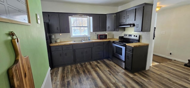 kitchen featuring dark hardwood / wood-style floors, stainless steel electric range oven, sink, and wood counters