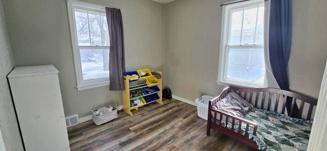 bedroom with dark hardwood / wood-style flooring