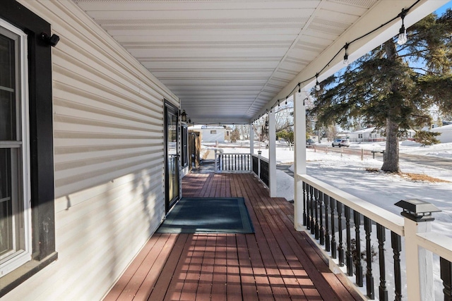 snow covered deck with covered porch