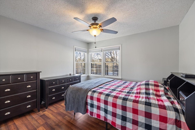 bedroom with ceiling fan, dark hardwood / wood-style floors, and a textured ceiling