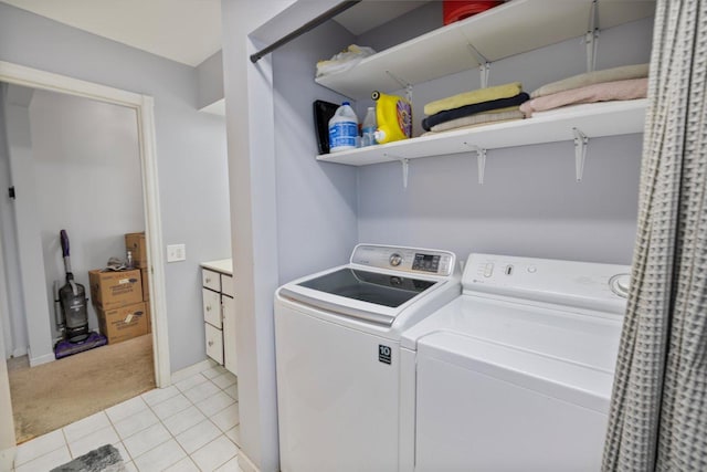 clothes washing area with light tile patterned floors and washing machine and clothes dryer