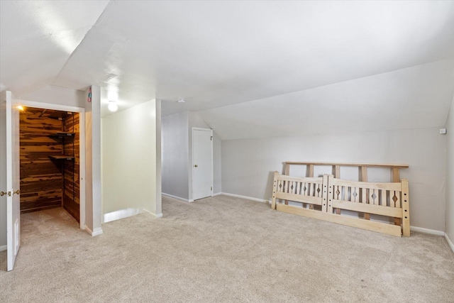 bonus room featuring light colored carpet and lofted ceiling