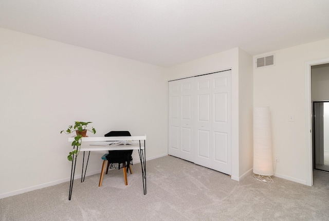 carpeted office with visible vents and baseboards