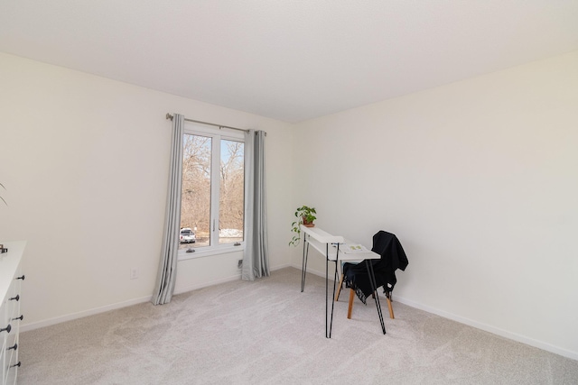 office area featuring light colored carpet and baseboards