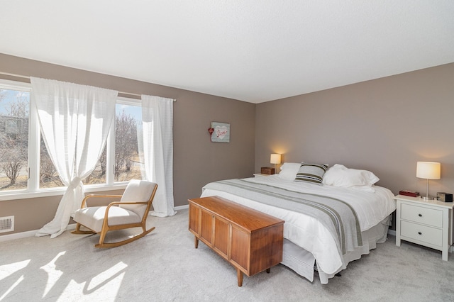 bedroom featuring light carpet, visible vents, and baseboards