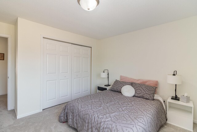 bedroom featuring a closet, carpet, and baseboards