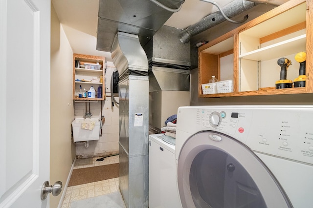 clothes washing area featuring laundry area and a sink