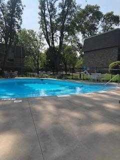 view of swimming pool with a patio area and a fenced in pool