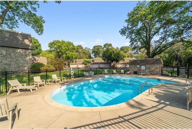 pool featuring fence and a patio