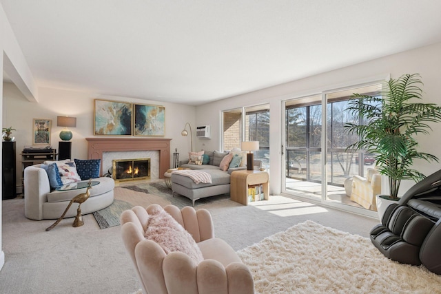 carpeted living room featuring a glass covered fireplace and an AC wall unit