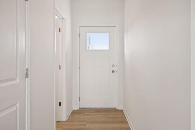 doorway to outside with light wood-type flooring