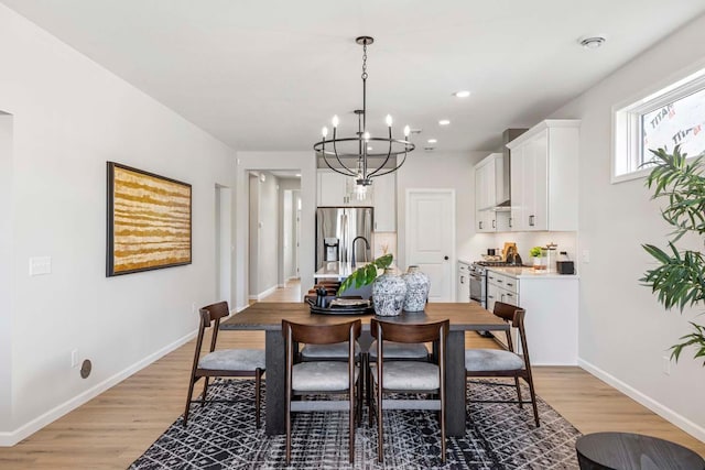 10974 37th St N, Lake Elmo, MN 55042 - dining space featuring baseboards, recessed lighting, light wood-style flooring, and a chandelier