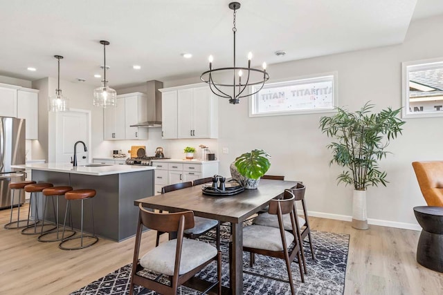10974 37th St N, Lake Elmo, MN 55042 - dining space featuring light wood-style floors, recessed lighting, baseboards, and a notable chandelier