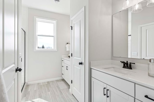 10974 37th St N, Lake Elmo, MN 55042 - bathroom featuring an enclosed shower, baseboards, and vanity