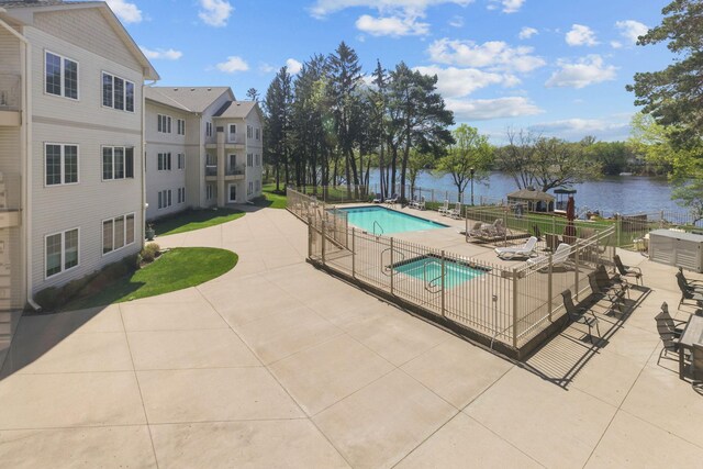 11030 Mississippi Blvd NW Unit 221, Coon Rapids, MN 55433 - community pool with fence, a patio area, and a water view