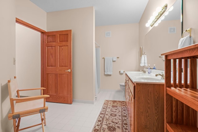 11030 Mississippi Blvd NW Unit 221, Coon Rapids, MN 55433 - bathroom with tile patterned floors, double vanity, a shower, toilet, and baseboards