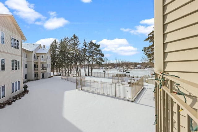 11030 Mississippi Blvd NW Unit 221, Coon Rapids, MN 55433 - snowy yard with fence and a patio area