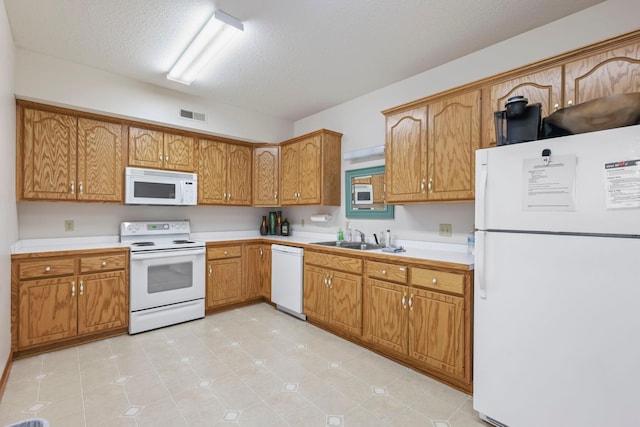 11030 Mississippi Blvd NW Unit 221, Coon Rapids, MN 55433 - kitchen featuring white appliances, a sink, light countertops, brown cabinetry, and a textured ceiling