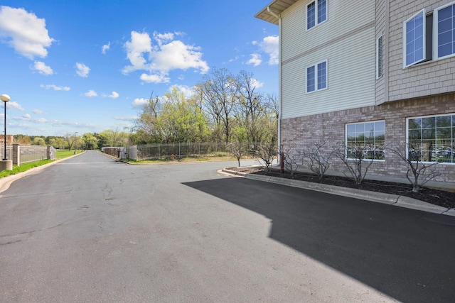 11030 Mississippi Blvd NW Unit 221, Coon Rapids, MN 55433 - view of asphalt street with curbs and street lights